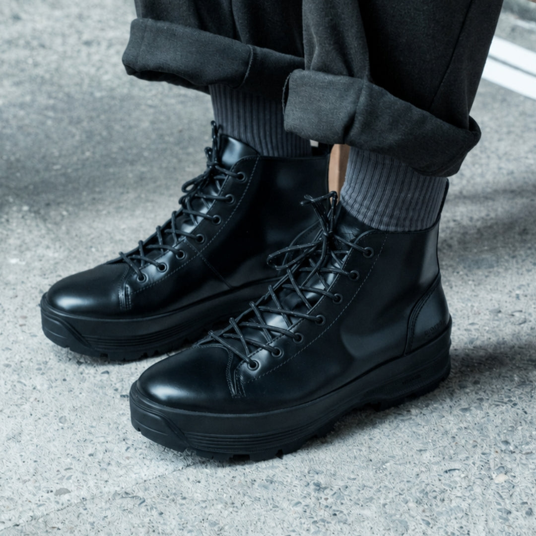 OSWEN City Explorer black leather lace-up boots worn outdoors.
