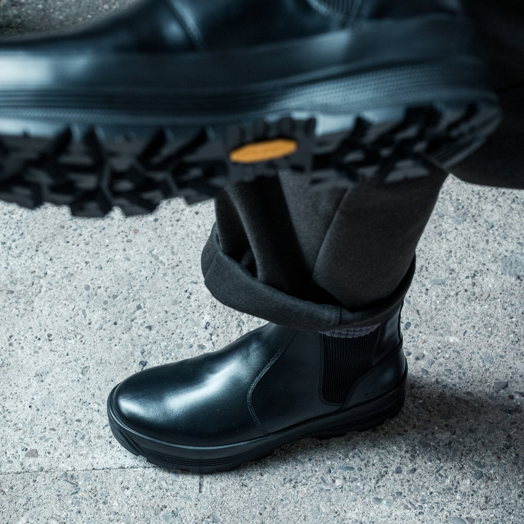 OSWEN City Commuter black leather Chelsea boot worn outdoors.