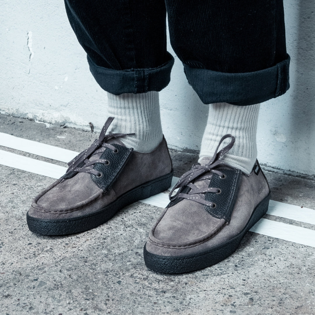 OSWEN Konrad Low shoes in Taupe suede and leather worn with casual trousers.