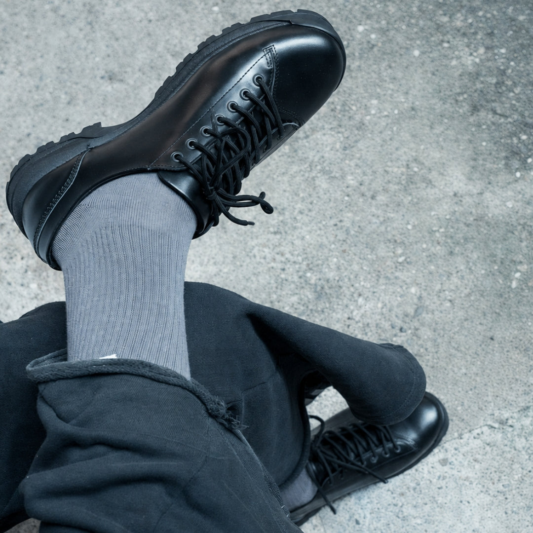 OSWEN City Explorer Low black leather lace-up shoes worn outdoors.