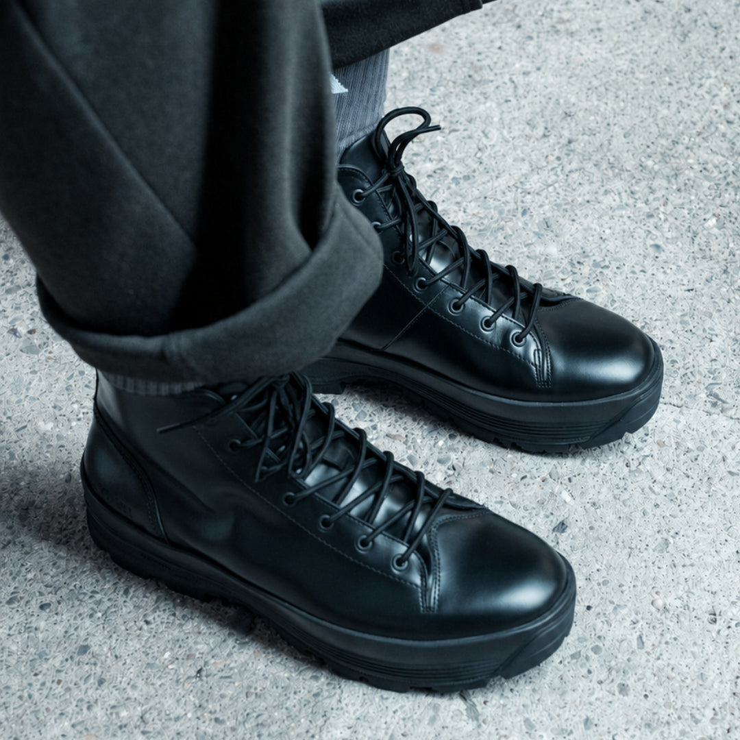 OSWEN City Explorer black leather lace-up boots worn outdoors.